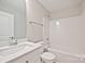 A clean bathroom showcasing a vanity with quartz countertop and tub shower at 417 Spring Sw St, Concord, NC 28025