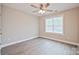 Neutral bedroom offering ceiling fan, window for natural light, and wood-look flooring at 417 Spring Sw St, Concord, NC 28025