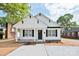 Inviting home with a covered porch, black door and shutters, and a freshly landscaped front yard at 417 Spring Sw St, Concord, NC 28025