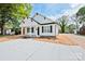 Charming single-story home with a white exterior, black shutters, and a well-manicured front yard at 417 Spring Sw St, Concord, NC 28025