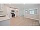 Bright, open-concept kitchen featuring stainless appliances and wood-look flooring throughout at 417 Spring Sw St, Concord, NC 28025