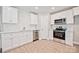 Bright kitchen featuring stainless steel appliances, white cabinets and subway tile backsplash at 417 Spring Sw St, Concord, NC 28025