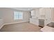 A functional kitchenette with white cabinetry, stainless steel dishwasher, and natural light at 417 Spring Sw St, Concord, NC 28025