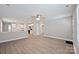 Open-concept living space connecting to the kitchen, featuring hardwood floors and neutral walls at 417 Spring Sw St, Concord, NC 28025