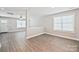 Bright, open-concept living room with wood-look flooring and natural light from windows at 417 Spring Sw St, Concord, NC 28025