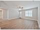Spacious living room with a light interior, hardwood flooring, and access to other rooms at 417 Spring Sw St, Concord, NC 28025