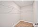 An organized walk-in closet with wire shelving and wood-look flooring at 417 Spring Sw St, Concord, NC 28025