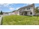 Expansive backyard view featuring a white picket fence, an enclosed screened porch, and a lush green lawn at 428 Whitewater Nw Way, Concord, NC 28027