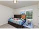 Bright bedroom with a built-in headboard, drawers, and a view from the double window at 428 Whitewater Nw Way, Concord, NC 28027