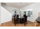 Bright dining area features a modern chandelier, dark wood table set and natural light from the large windows at 428 Whitewater Nw Way, Concord, NC 28027