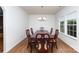 Formal dining room with hardwood floors, chandelier, and a large wooden table with decorative chairs at 428 Whitewater Nw Way, Concord, NC 28027