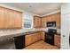 Efficient kitchen features wood cabinets, granite countertops, black appliances, and ample counter space at 428 Whitewater Nw Way, Concord, NC 28027