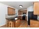 Functional kitchen features wood cabinets, black appliances, granite countertops, and bar seating at 428 Whitewater Nw Way, Concord, NC 28027