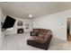 Spacious living room with fireplace, plush carpet, and brown reclining sofa for ultimate comfort and relaxation at 428 Whitewater Nw Way, Concord, NC 28027