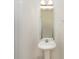 The powder room features a pedestal sink, an elegant mirror, and modern lighting at 428 Whitewater Nw Way, Concord, NC 28027
