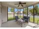 Relaxing screened porch with ceiling fan, outdoor seating, and view of the backyard at 428 Whitewater Nw Way, Concord, NC 28027