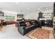 Finished basement with a leather sofa, tile flooring, kitchenette, and space for entertaining at 4925 Pageland Hwy, Monroe, NC 28112