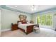 Cozy bedroom featuring soft lighting, a comfortable bed, and serene backyard views at 4925 Pageland Hwy, Monroe, NC 28112