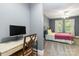 Comfortable bedroom with a desk area and a cozy bed with neutral tones and natural light at 4925 Pageland Hwy, Monroe, NC 28112