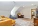 Inviting bonus room featuring plush seating, a unique rug, and a cozy atmosphere with natural light at 4925 Pageland Hwy, Monroe, NC 28112