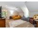 Spacious bonus room with a large sofa, beanbag, and cozy seating area under an angled ceiling at 4925 Pageland Hwy, Monroe, NC 28112