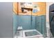 Pet-washing station featuring blue tiled walls, handheld shower, and a practical, accessible design at 4925 Pageland Hwy, Monroe, NC 28112
