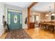 Welcoming entryway with a decorative blue door, hardwood floors, and a view into the dining area at 4925 Pageland Hwy, Monroe, NC 28112