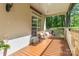 Charming front porch featuring a wooden swing, stone accents, and ample space for relaxation at 4925 Pageland Hwy, Monroe, NC 28112