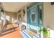 Inviting front porch with a blue door, wooden swing, and a charming welcome mat at 4925 Pageland Hwy, Monroe, NC 28112