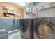 Well-organized laundry room featuring a pet-washing station and modern washer and dryer for convenience at 4925 Pageland Hwy, Monroe, NC 28112