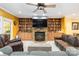 Inviting living room with custom built-ins, stone fireplace, and large tv at 4925 Pageland Hwy, Monroe, NC 28112