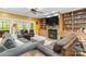 Inviting living room featuring a stone fireplace, built-in bookshelves, and comfortable seating at 4925 Pageland Hwy, Monroe, NC 28112