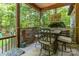 Covered outdoor patio with dining table, chairs, and a view of the lush green yard at 4925 Pageland Hwy, Monroe, NC 28112