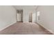 Carpeted bedroom with three doorways, one window, and neutral paint at 5602 Skinny Dr, Charlotte, NC 28215