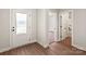 Bright entryway with wood-look flooring, white trim and doors, and a frosted glass front door at 5602 Skinny Dr, Charlotte, NC 28215