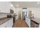 Spacious kitchen showcasing granite countertops, modern appliances, and sleek white cabinetry at 5602 Skinny Dr, Charlotte, NC 28215