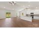 Open-concept living space with vaulted ceilings, wood floors, and a seamless transition to the kitchen at 5602 Skinny Dr, Charlotte, NC 28215