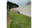 Exterior featuring a wood deck, green grass, mature trees, and vinyl siding at 5767 Swinging Bridge Rd, Conover, NC 28613
