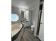 Bathroom featuring a large tub, shower, modern vanity, and wood-look flooring at 5767 Swinging Bridge Rd, Conover, NC 28613