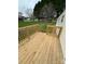 Wood deck with railing overlooking green grass and tree-lined backyard at 5767 Swinging Bridge Rd, Conover, NC 28613