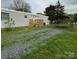 Well-maintained single-story home featuring a deck and covered parking, set on a spacious lot with gravel driveway at 5767 Swinging Bridge Rd, Conover, NC 28613
