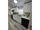 Well-lit kitchen featuring modern white cabinetry and sleek black appliances at 5767 Swinging Bridge Rd, Conover, NC 28613