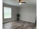 Cozy living room featuring modern gray flooring, neutral walls, and natural light from the window at 5767 Swinging Bridge Rd, Conover, NC 28613
