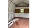 Spacious shed interior, features a window, peg board, and ample storage, ready for your hobbies and tools at 5767 Swinging Bridge Rd, Conover, NC 28613