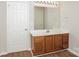 Bathroom with a single sink vanity, wooden cabinets and a large mirror with decorative lighting at 6111 Panache Dr, Matthews, NC 28104