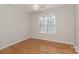 Cozy bedroom with hardwood floors, a ceiling fan and a window providing natural light at 6111 Panache Dr, Matthews, NC 28104