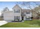 Charming two-story home with a well-manicured lawn and attached two-car garage at 6111 Panache Dr, Matthews, NC 28104