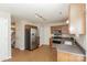 Well-lit kitchen with stainless steel appliances, wooden cabinets and modern lighting fixtures at 6111 Panache Dr, Matthews, NC 28104