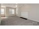 Comfortable living room with neutral carpet, a fireplace and a ceiling fan at 6111 Panache Dr, Matthews, NC 28104