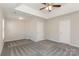 Large main bedroom with neutral carpet, a ceiling fan and access to closets and en-suite bathroom at 6111 Panache Dr, Matthews, NC 28104